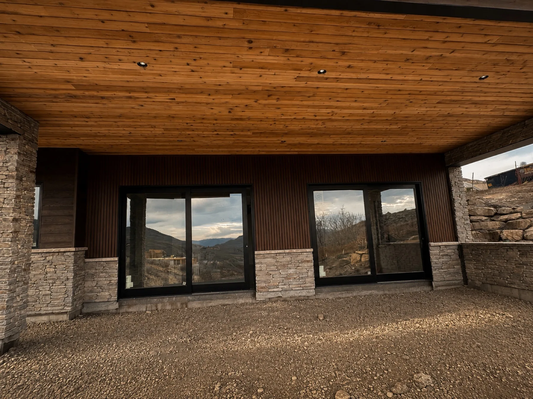 Covered patio with cedar tongue-and-groove ceiling and stone columns